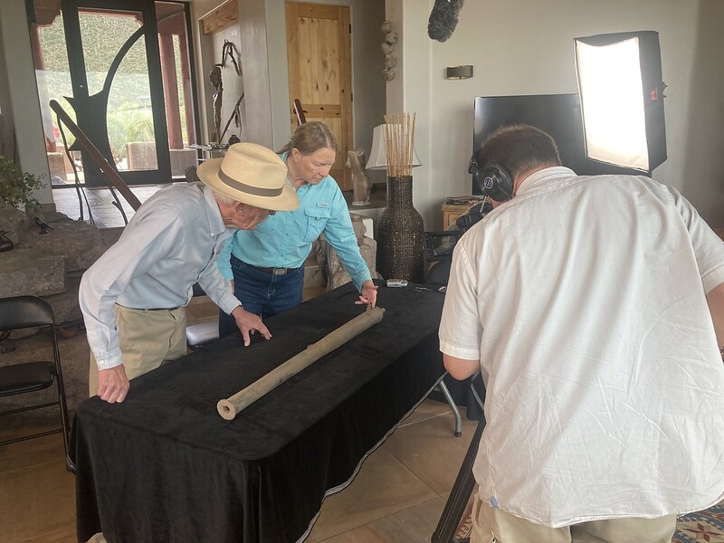 Deni Seymour PhD with 2 men examining Spanish cannon she discovered