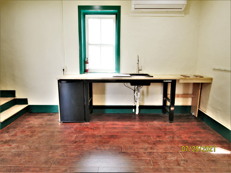 Bespoke sink assembly in finished room in front of window
